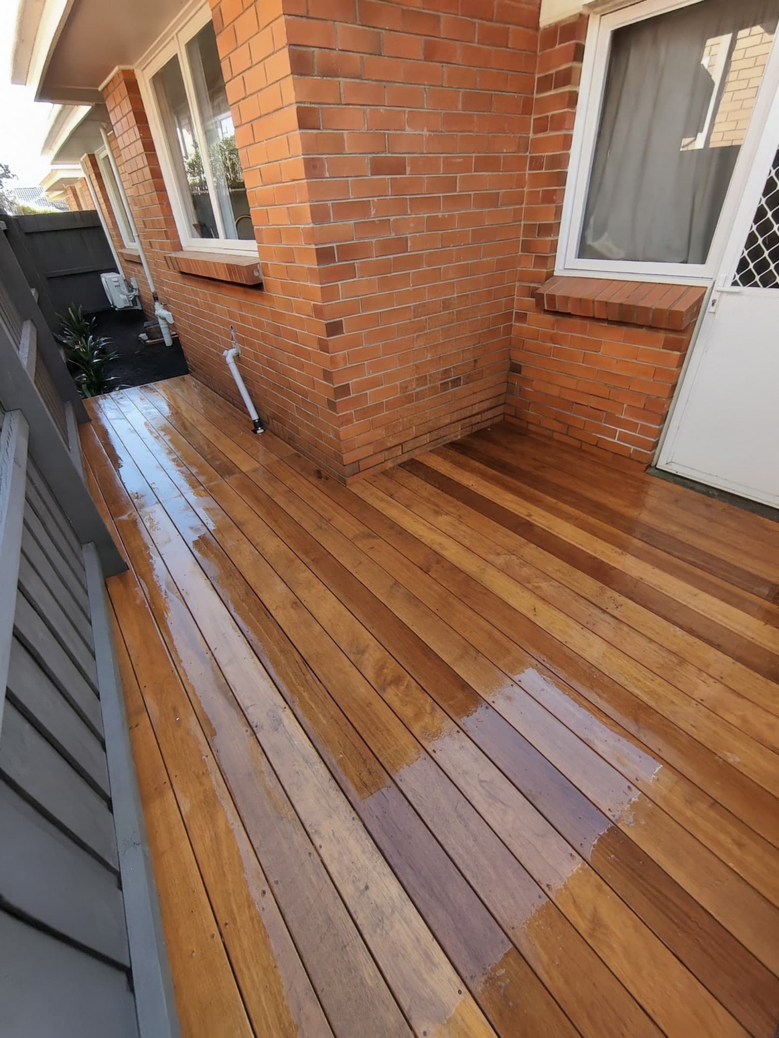 Oiled timber deck around brick home